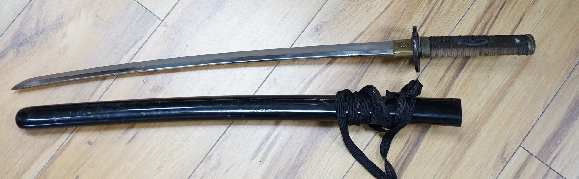 A 20th century Japanese wakizashi with cast iron ‘tiger’ tsuba, total length 73cm including scabbard
